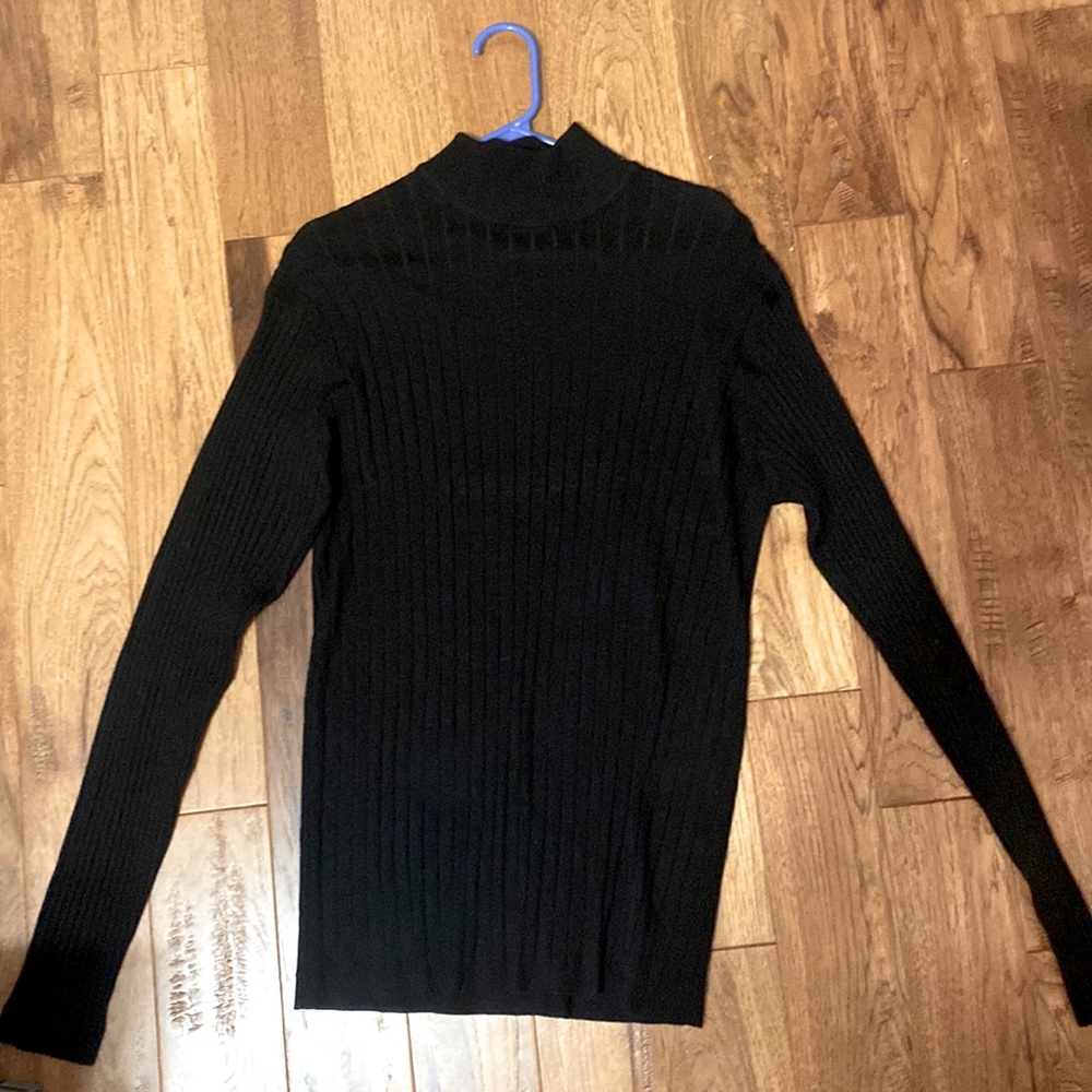 Black large sized turtle neck w/ ability to stretch.